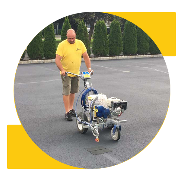person laying asphalt stripes